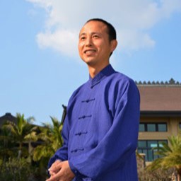 teacher smiling in traditional blue attire