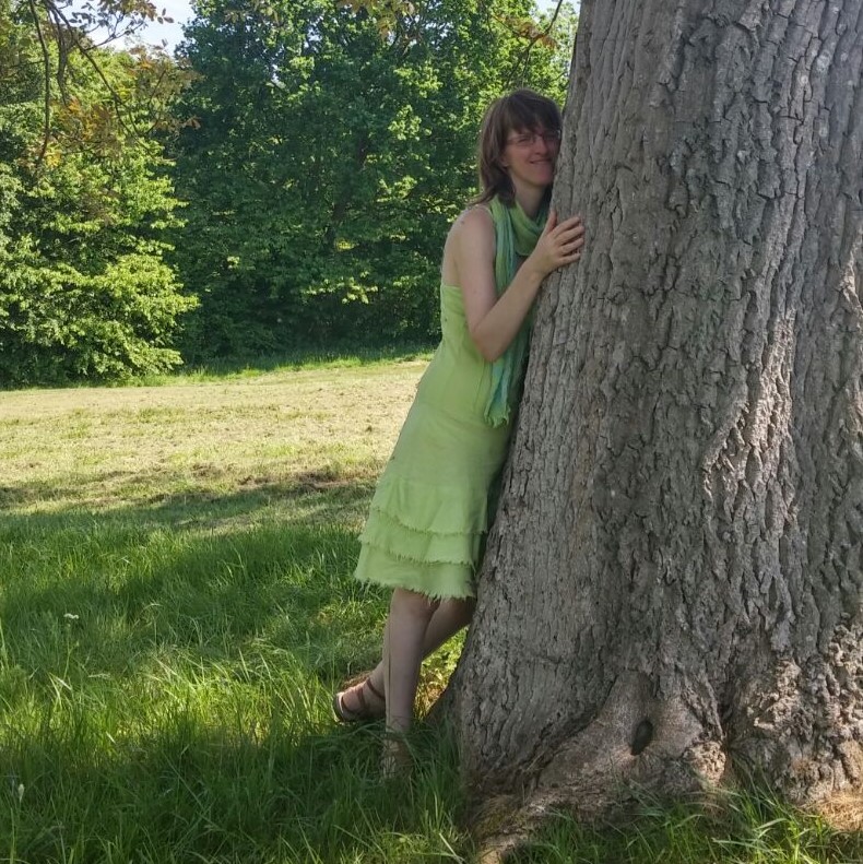 Qigong teacher hugging tree in nature